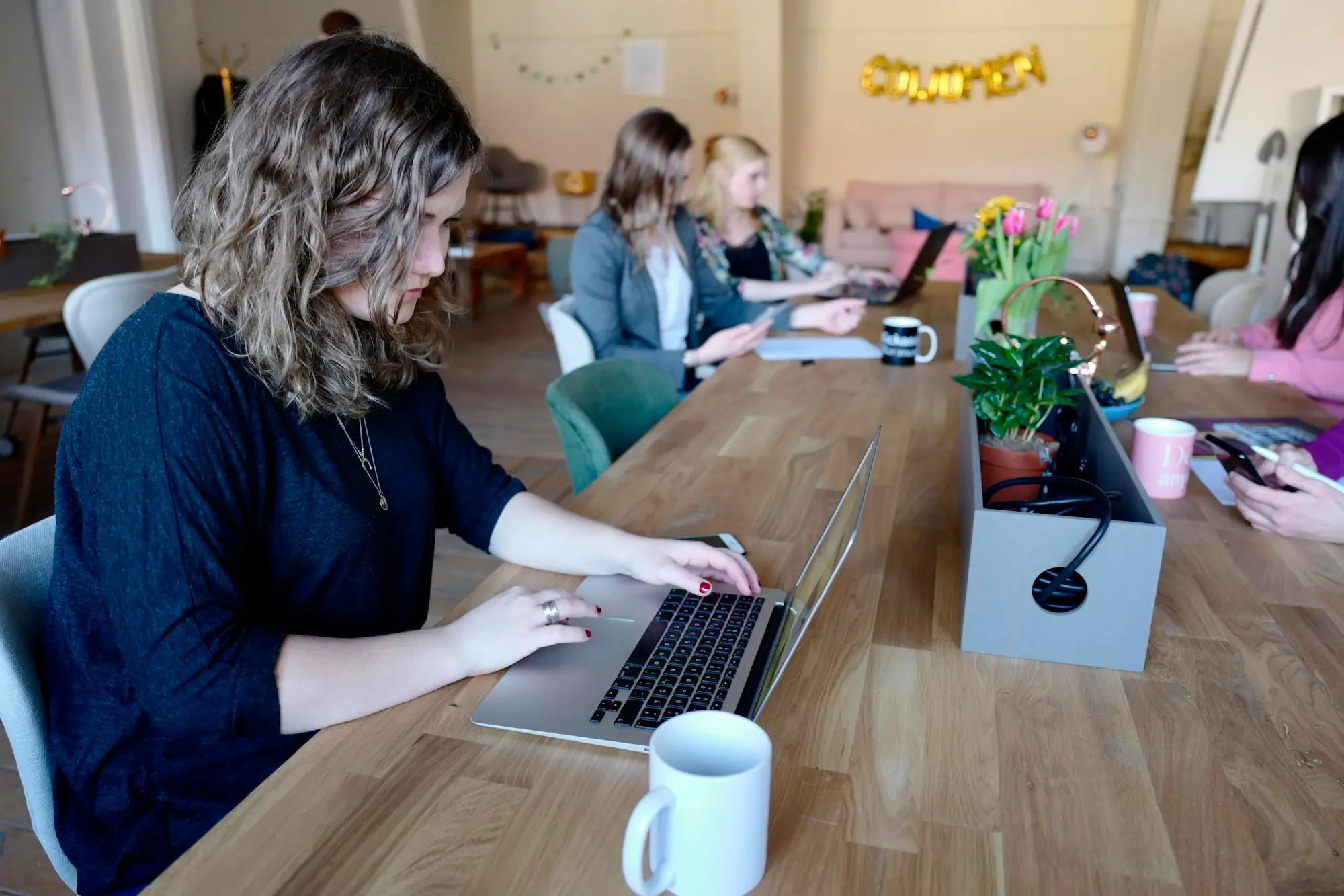 Woman working on a laptop in a shared office
