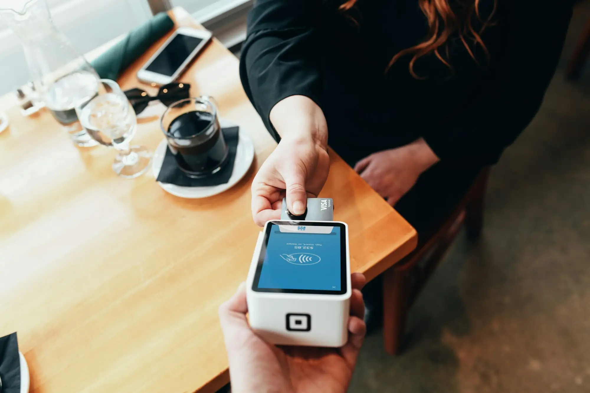 Customer holding a card payment terminal